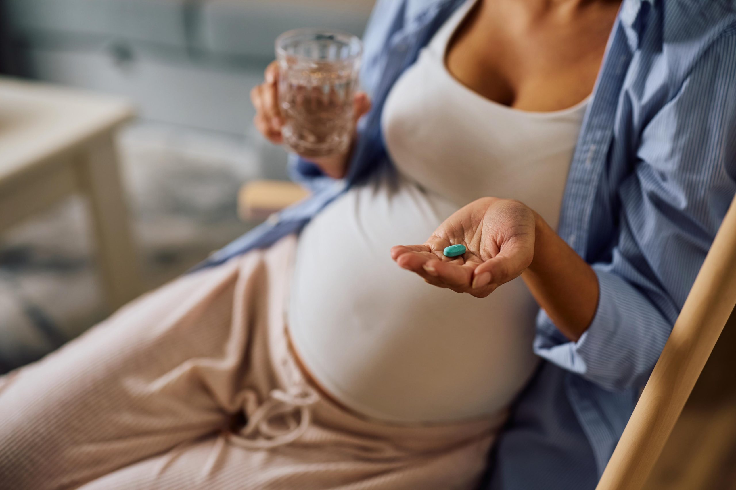 Pregnant woman taking vitamins.