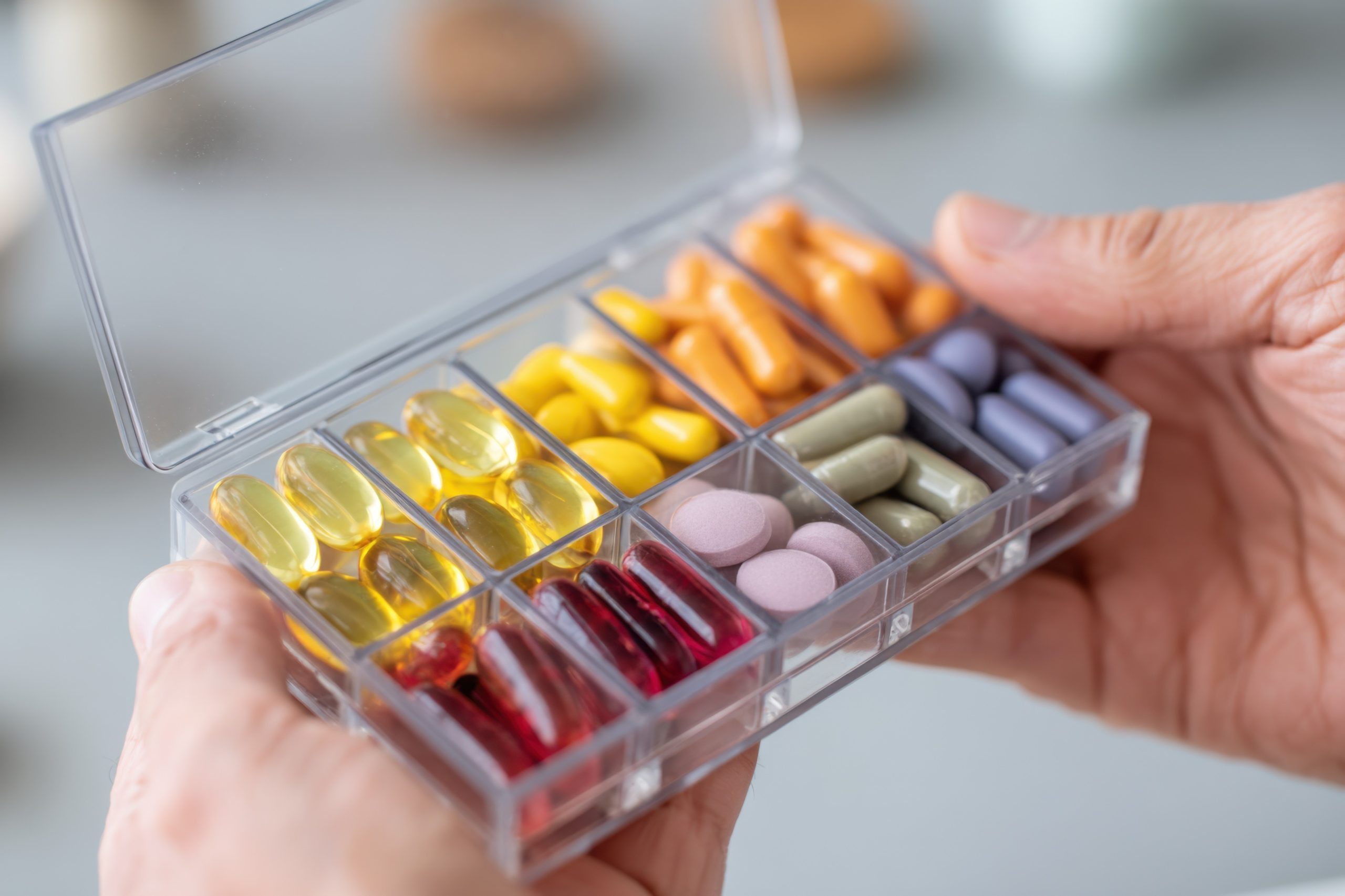 Assorted multivitamin tablets in various colors and shapes