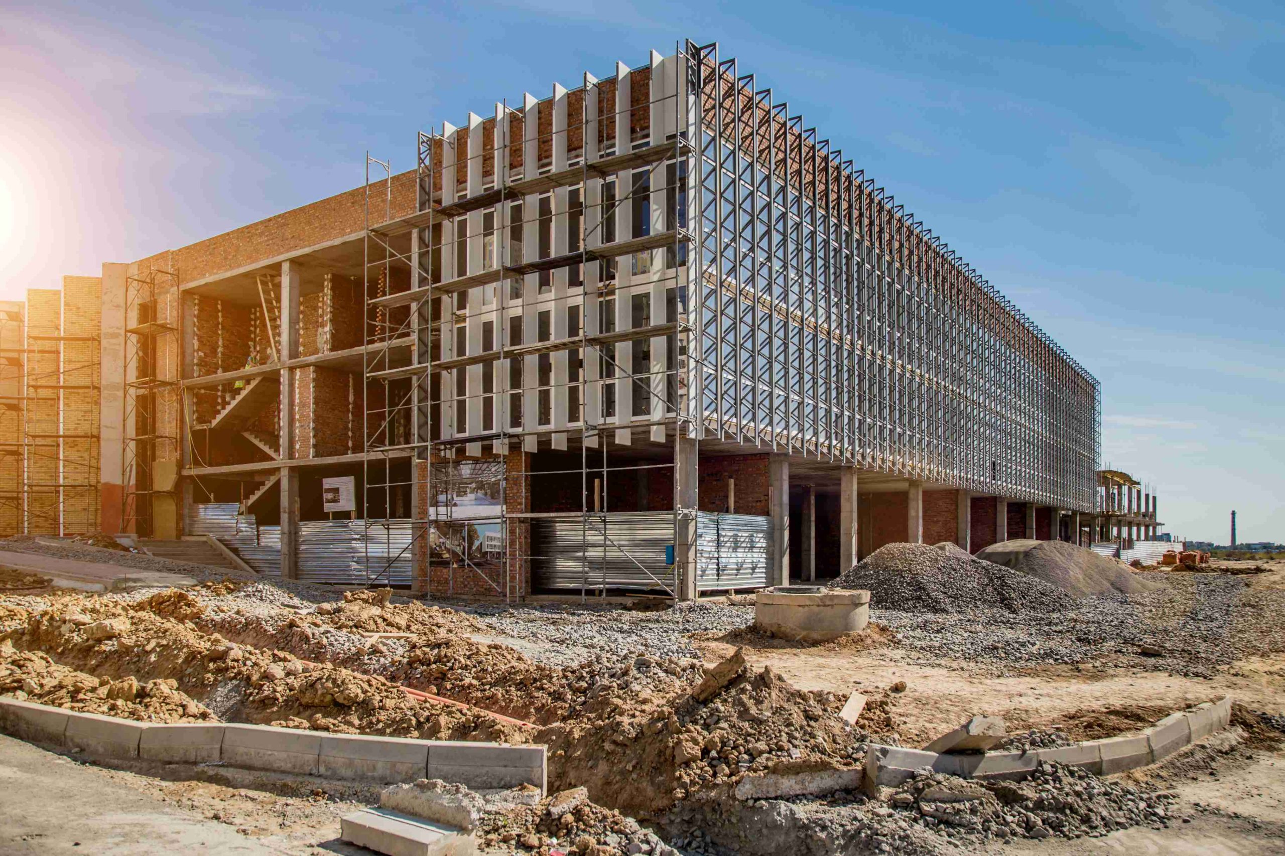 Construction site background. Hoisting cranes and new multi-storey buildings.