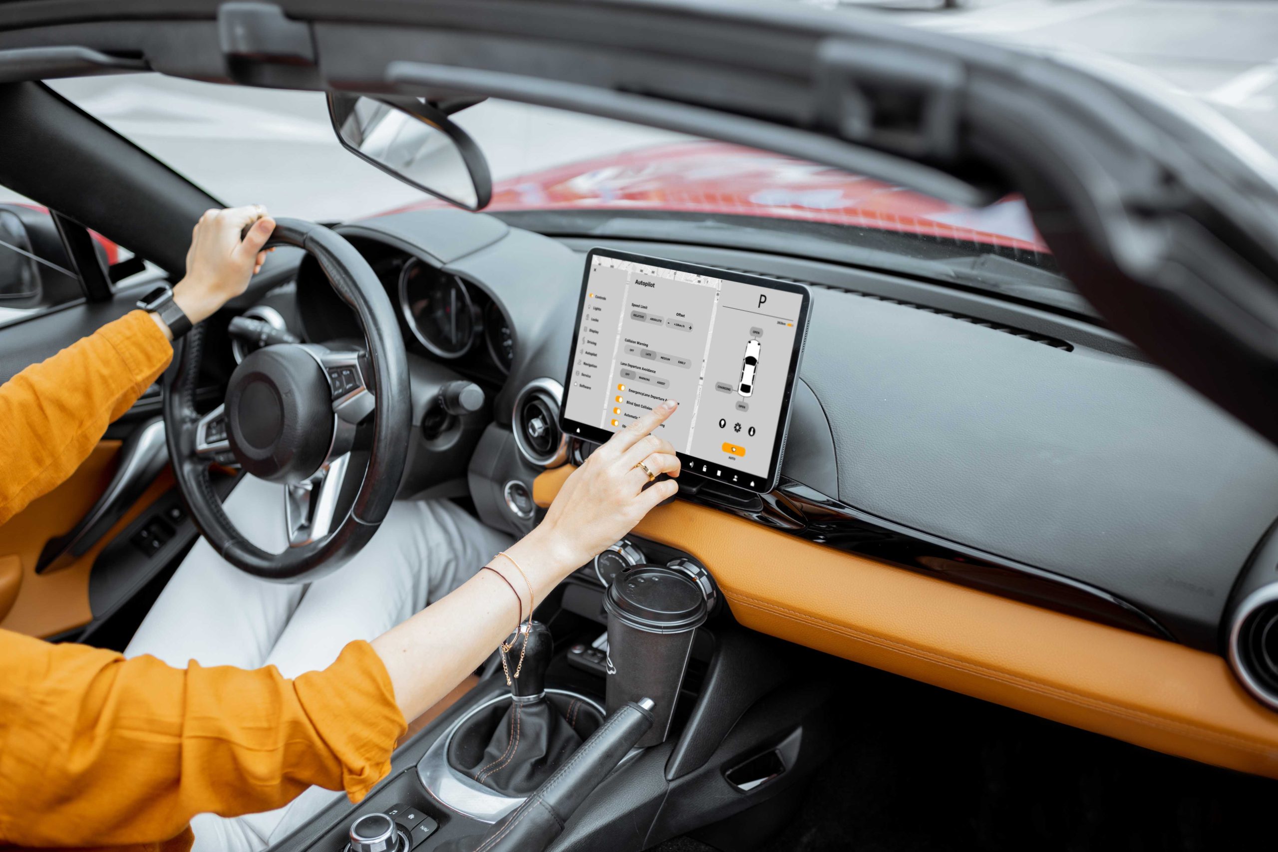 Cheerful woman controlling car with a digital dashboard, switching autopilot mode.