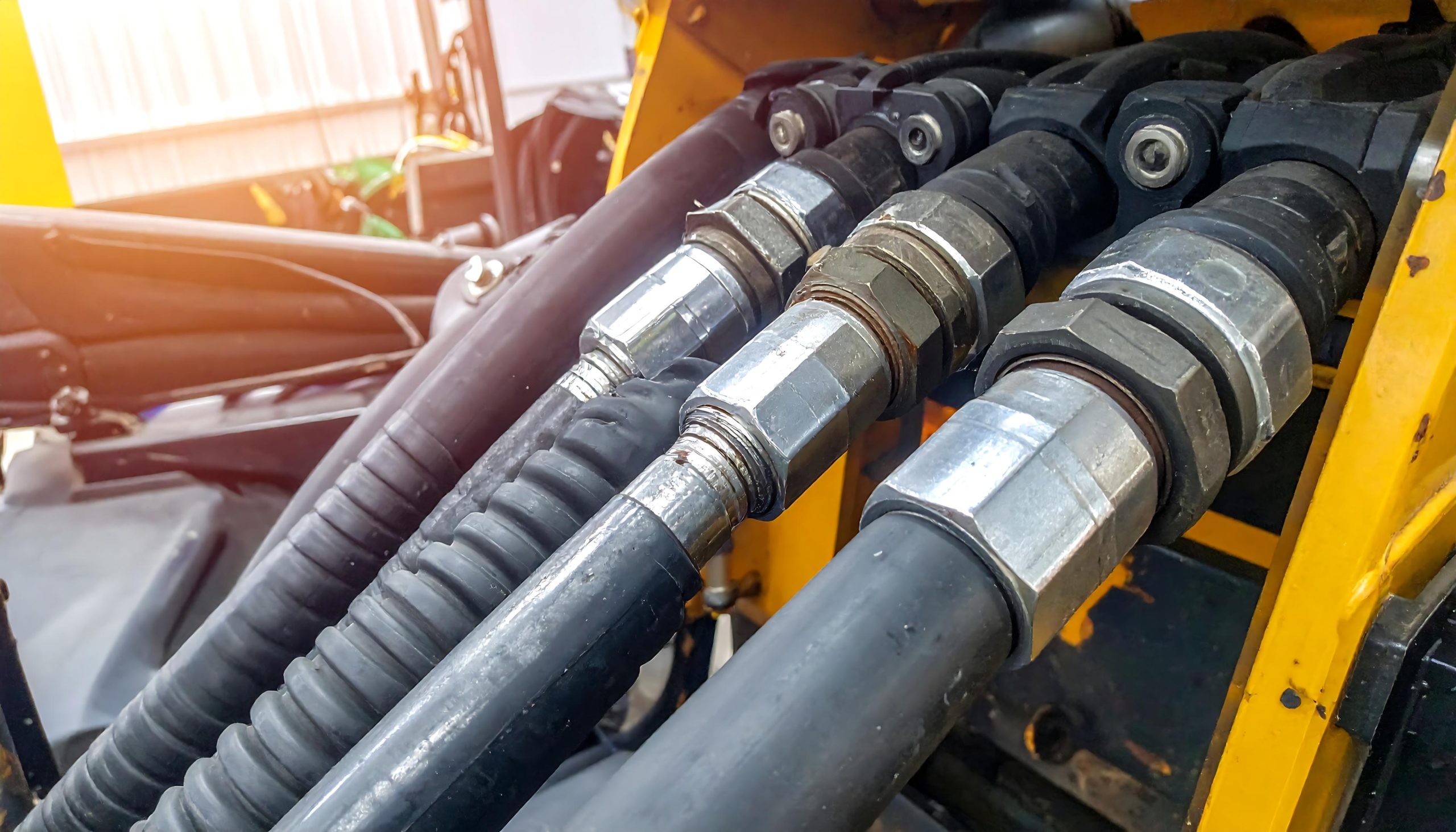 Industrial machinery with black rubber hoses.
