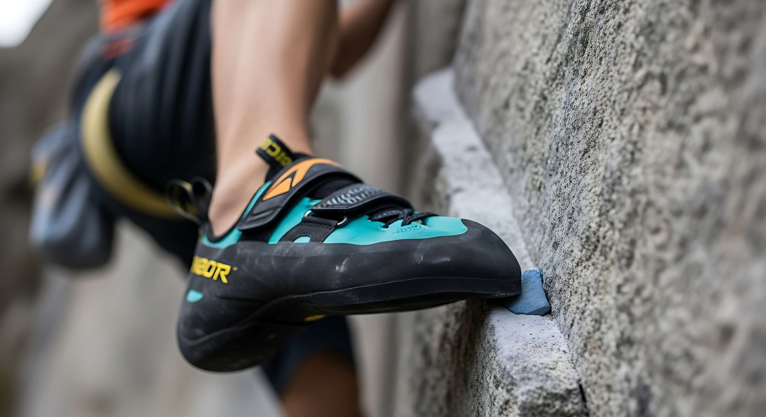 Rock climber's shoe gripping a hold during ascent, showcasing sport climbing adventure
