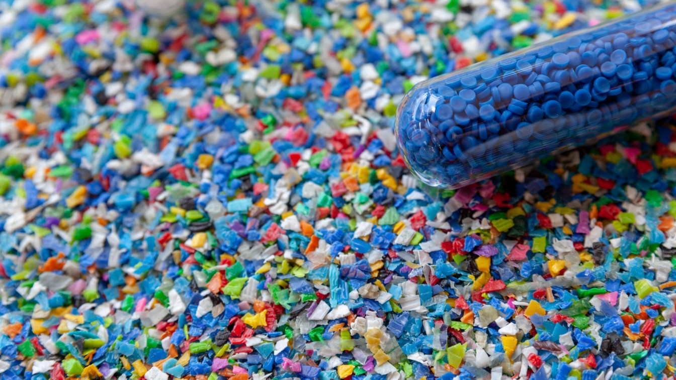 Crushed plastic granules for recycling. Plastic crusher. Recycled plastic with mixed colors. The concept of recycled plastic used.