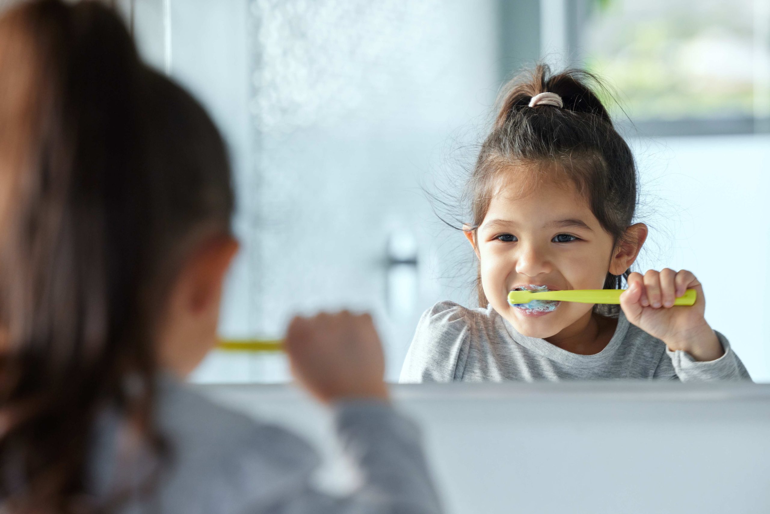 Girl brushing her teeth.
