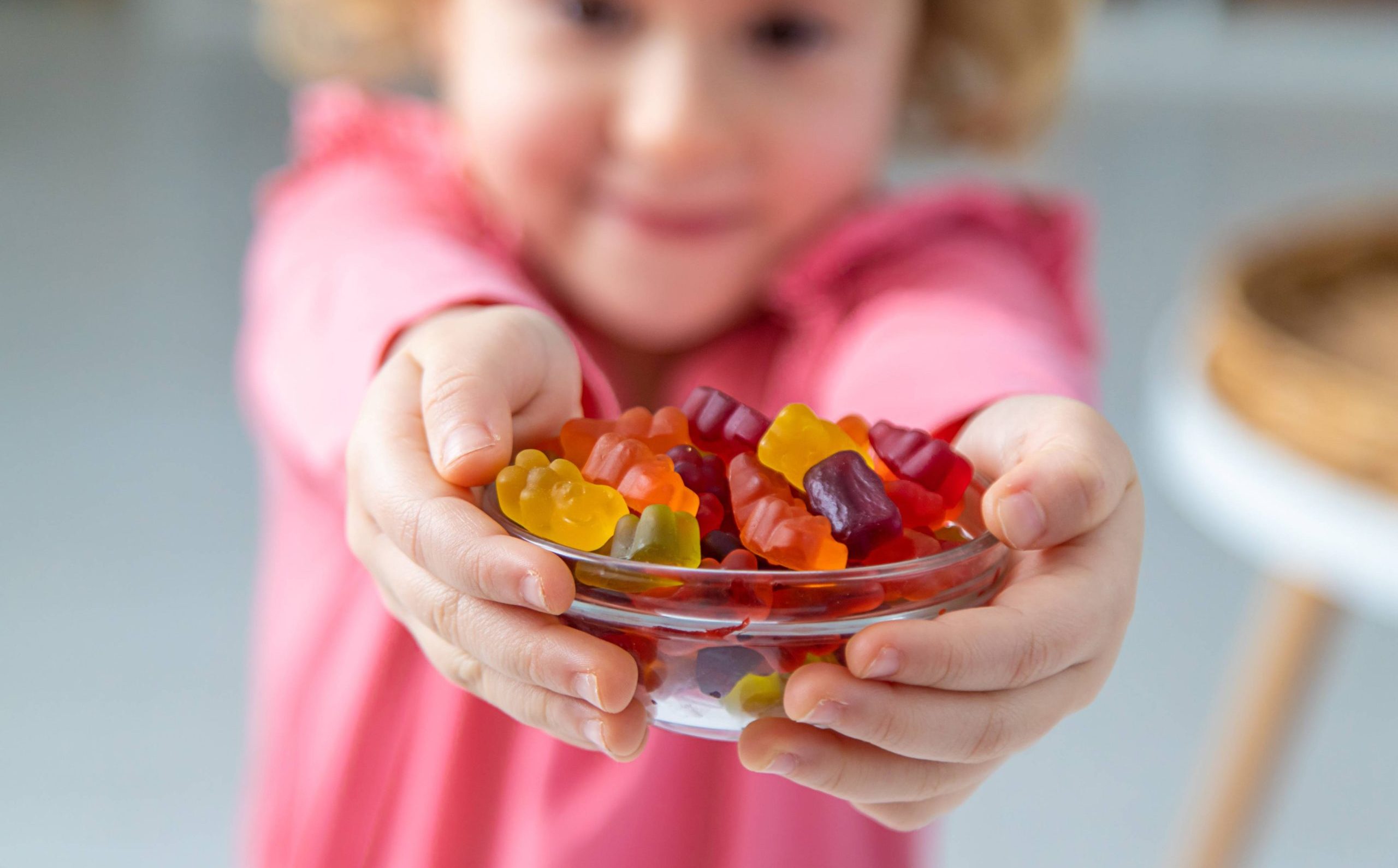 Child eating jelly candies at home. Selective focus.